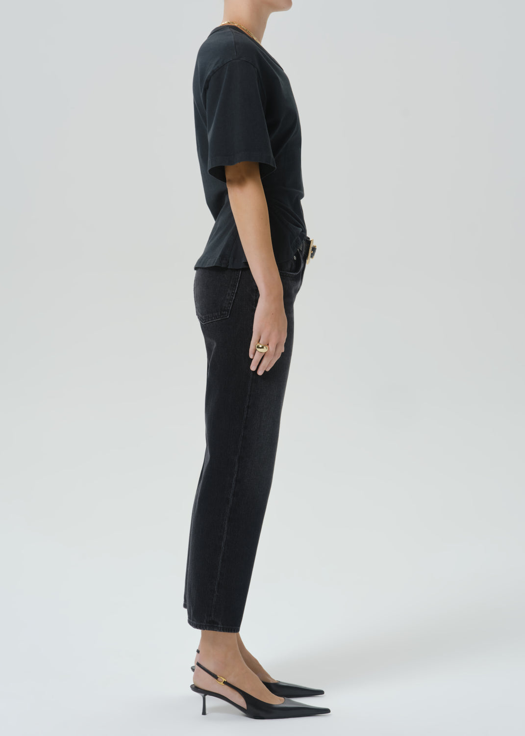 Side view of model wearing Citizens of Humanity Faye Vintage Straight jeans in dark black Raine wash