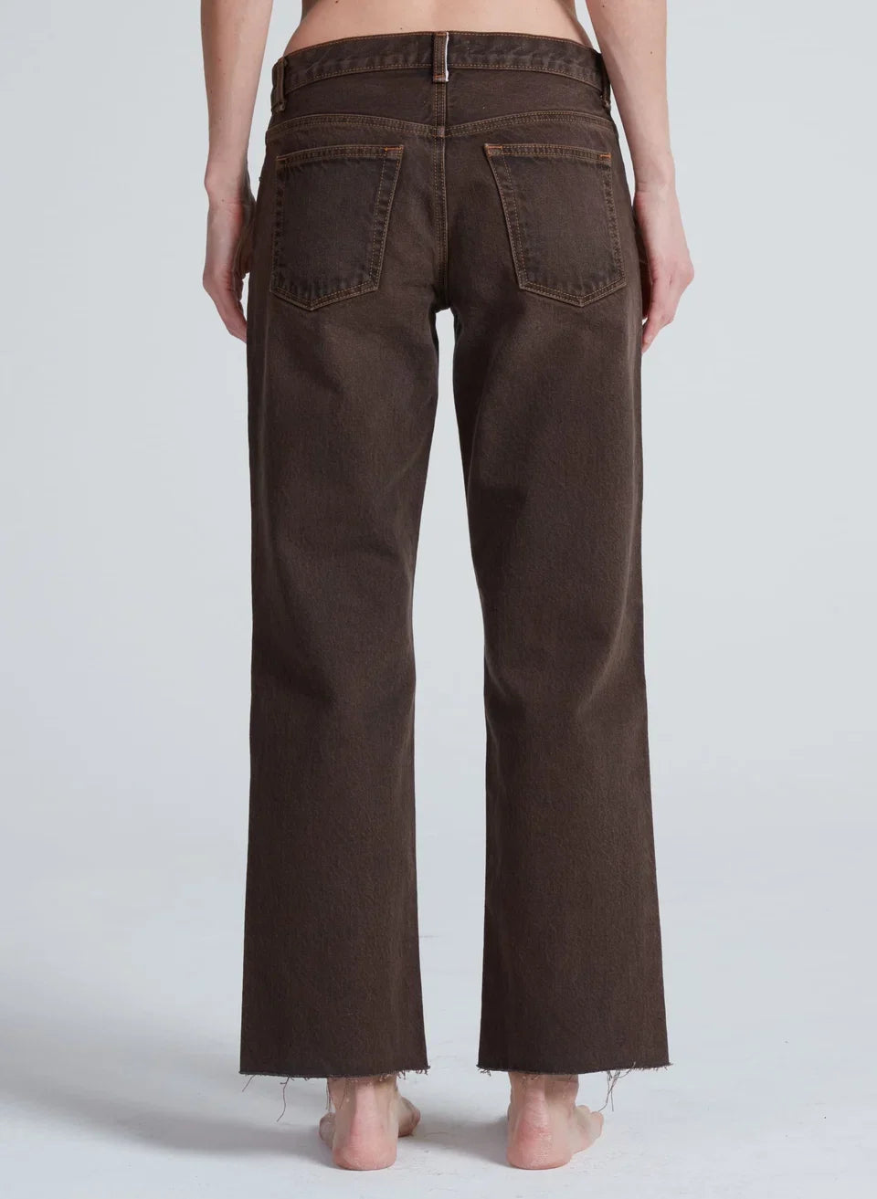 Back view of ASKK NY low rise straight leg brown denim jeans with raw hem