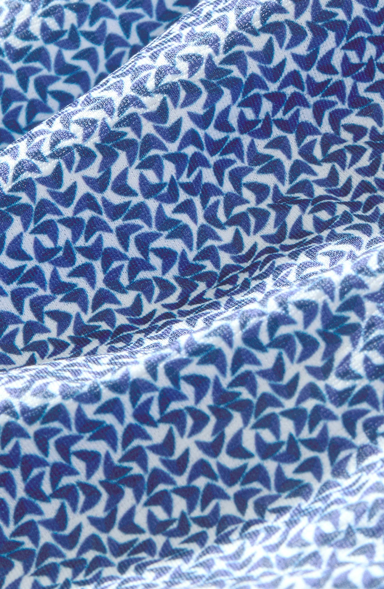 Close-up of cobalt blue boomerang geometric print on white performance shirt fabric