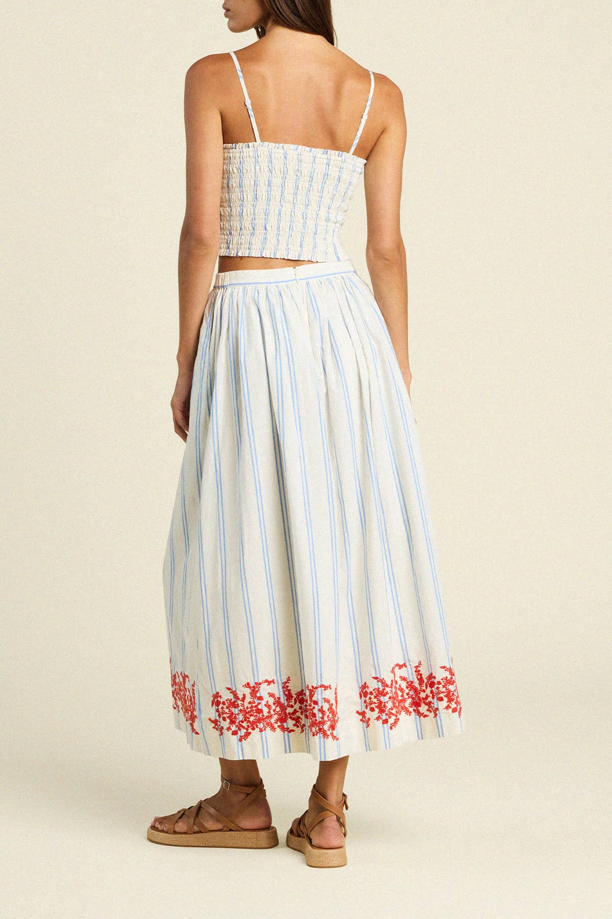 Trovata Lisette midi skirt with blue and white stripes and red floral embroidery at hem, shown from back