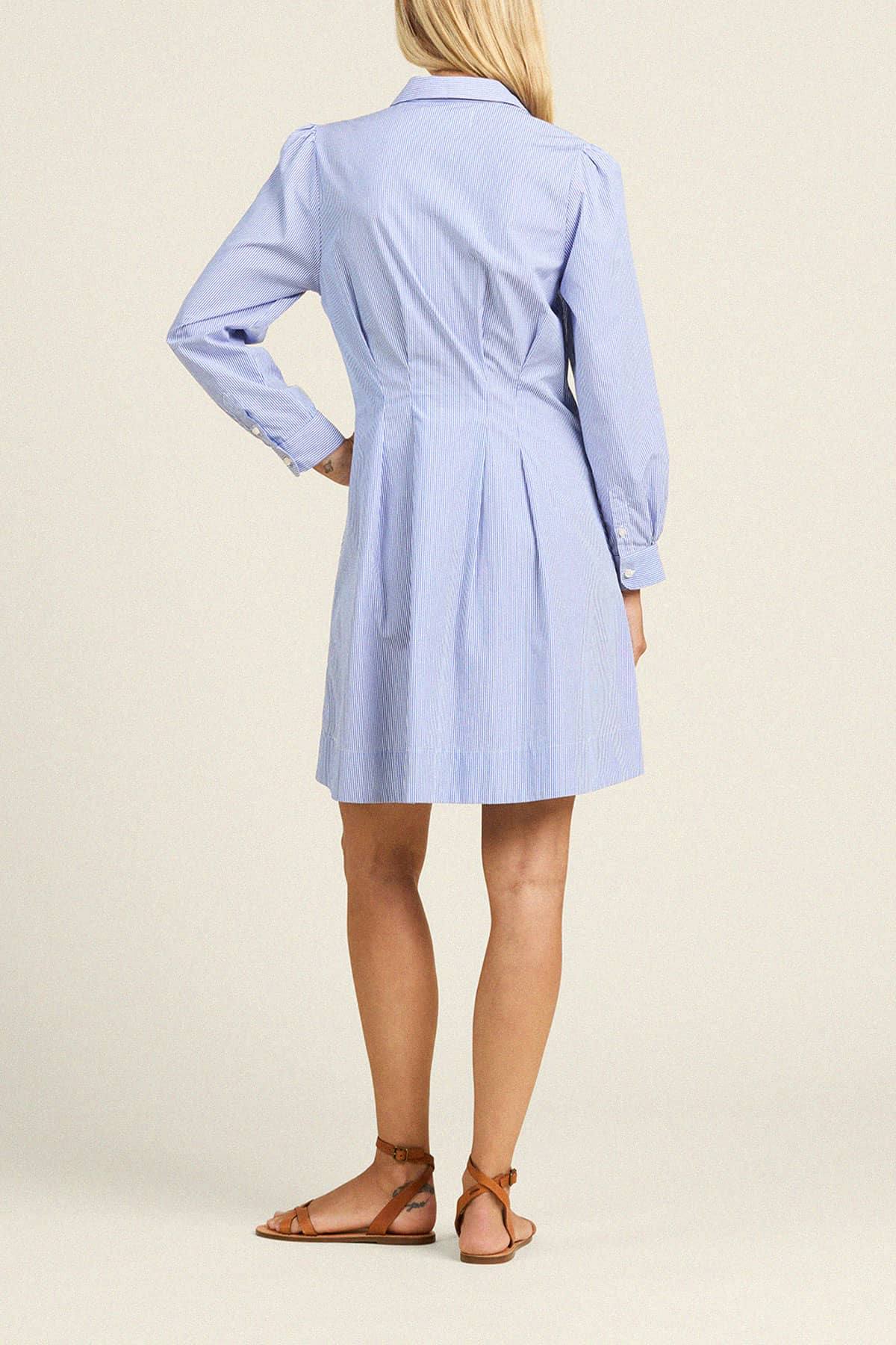 Trovata Lyra shirt dress in blue and white stripe pattern, shown from back view with long sleeves and knee-length hem.