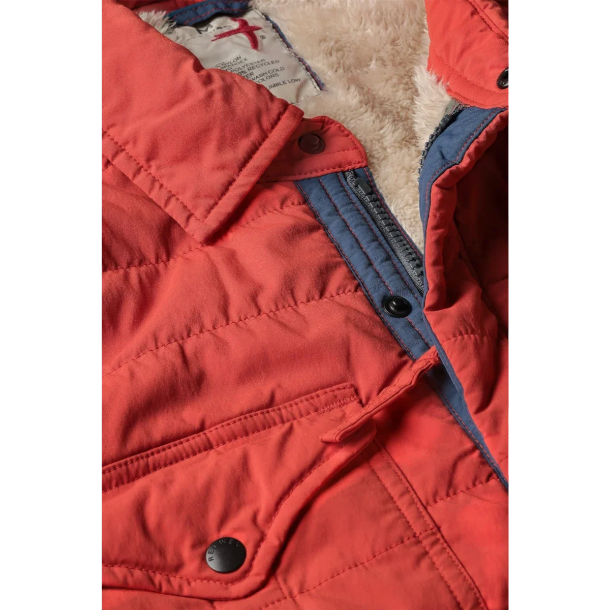 Close-up detail of Relwen Quilted Superfleece Jacket in dark orange showing sherpa lining and zipper