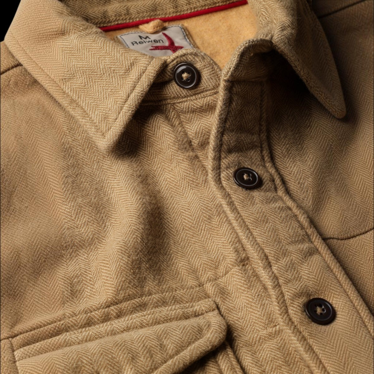 Close-up of Relwen Utility Workshirt in cornmeal herringbone weave with dark buttons