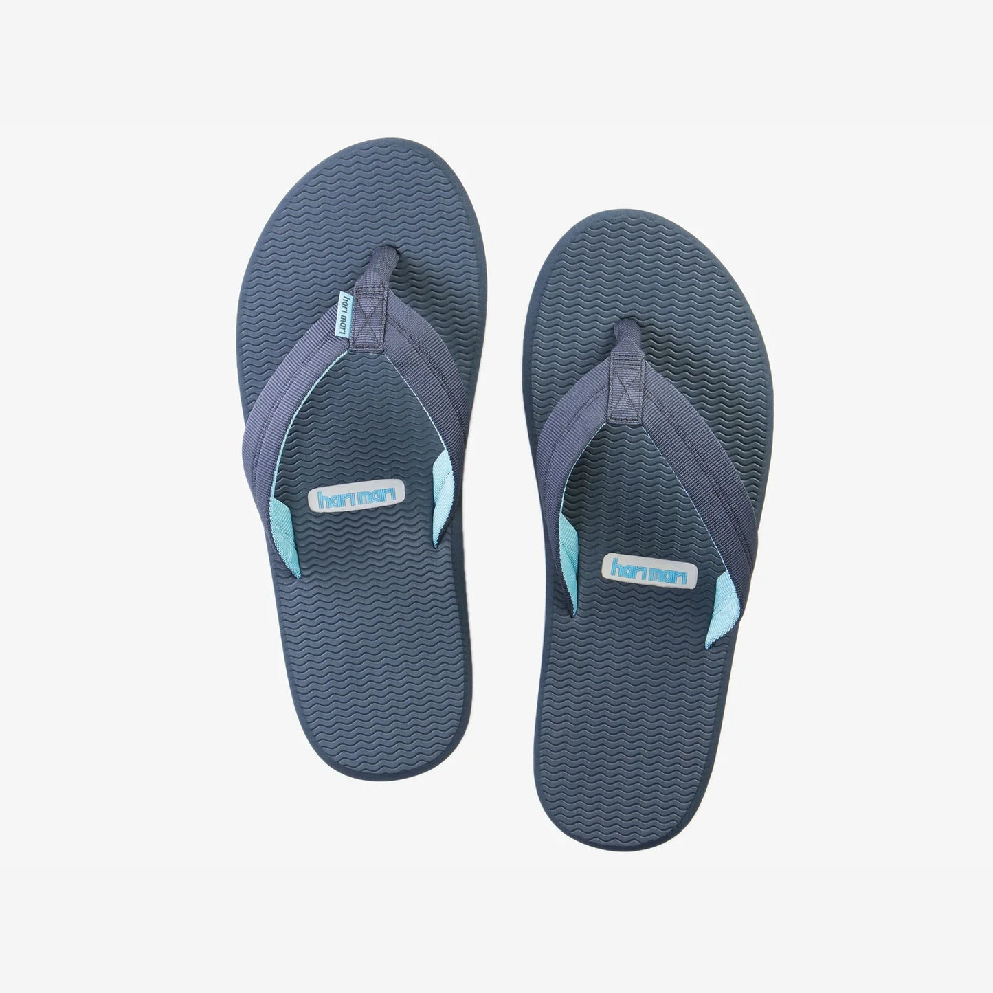 Hari Mari Dunes navy blue flip flops with textured soles and light blue accent straps on white background