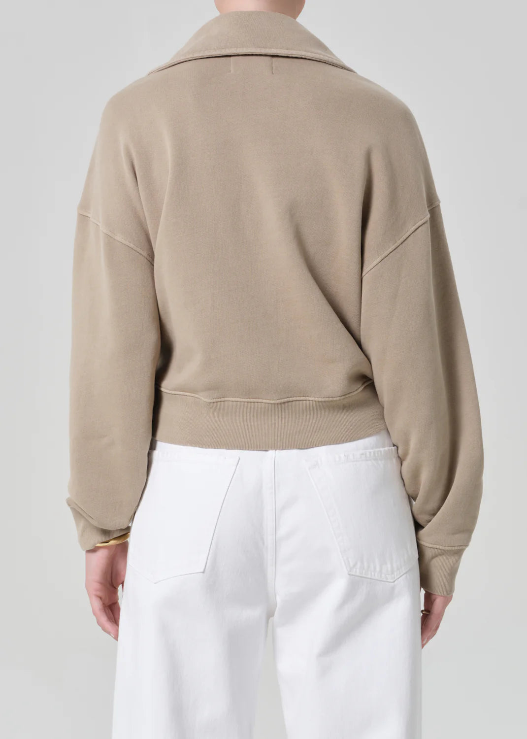 Back view of Citizens of Humanity Trapeze Pullover in beige, showing relaxed fit and ribbed hem details.