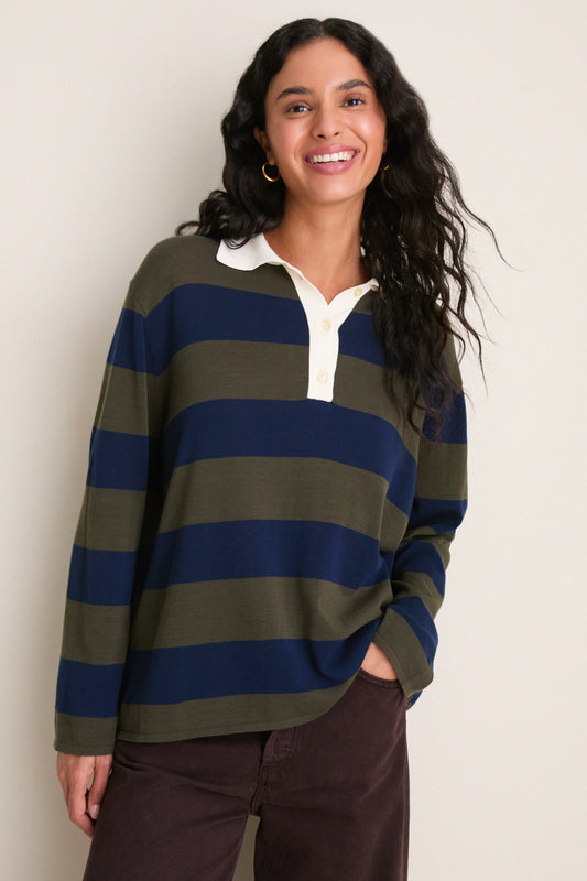 Model wearing oversized olive and navy striped rugby polo sweater with white collar