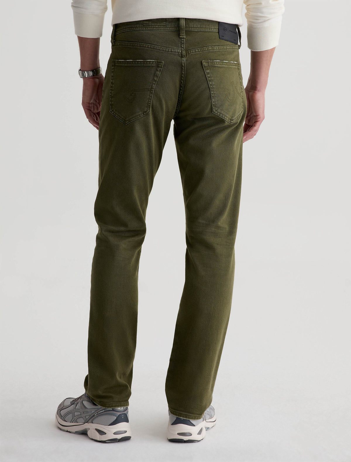 Back view of AG Everett slim straight jeans in olive green on male model