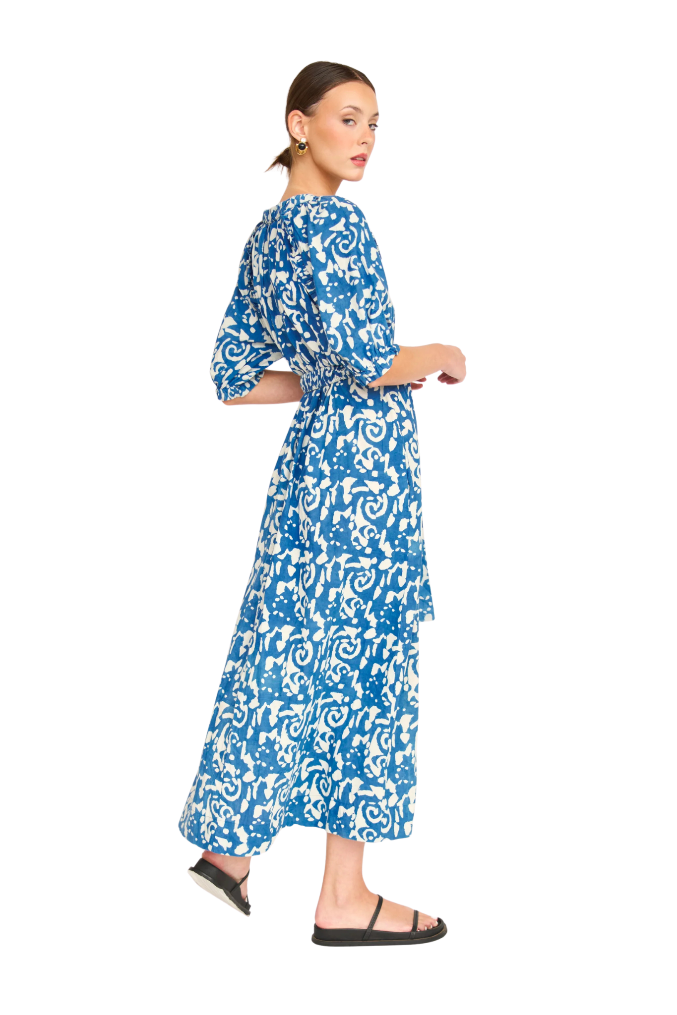 Woman wearing blue and white patterned maxi dress with three-quarter sleeves and tie waist