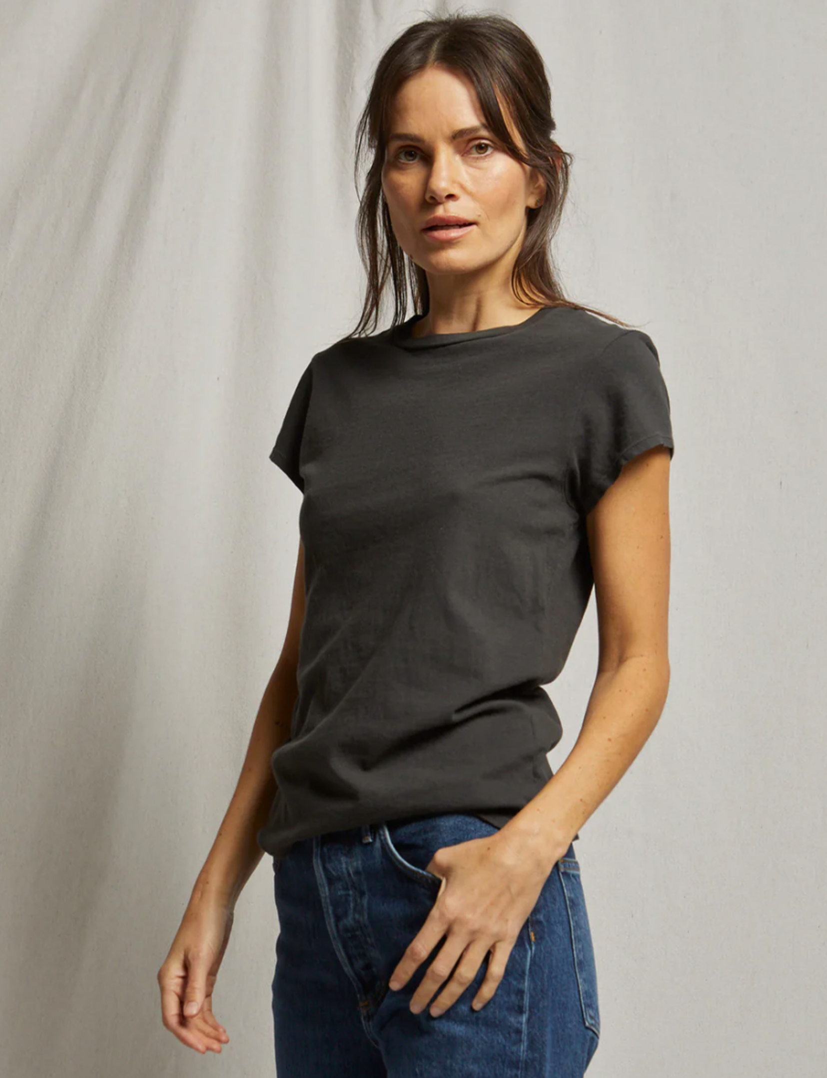 Woman wearing vintage black baby tee with jeans in professional lifestyle shot