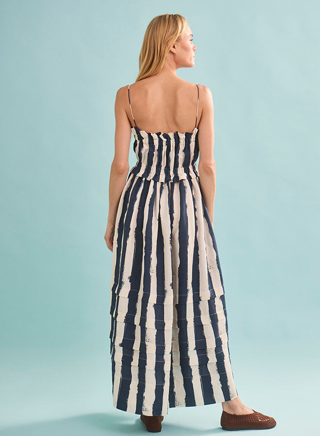 Woman wearing navy and white striped maxi dress viewed from behind