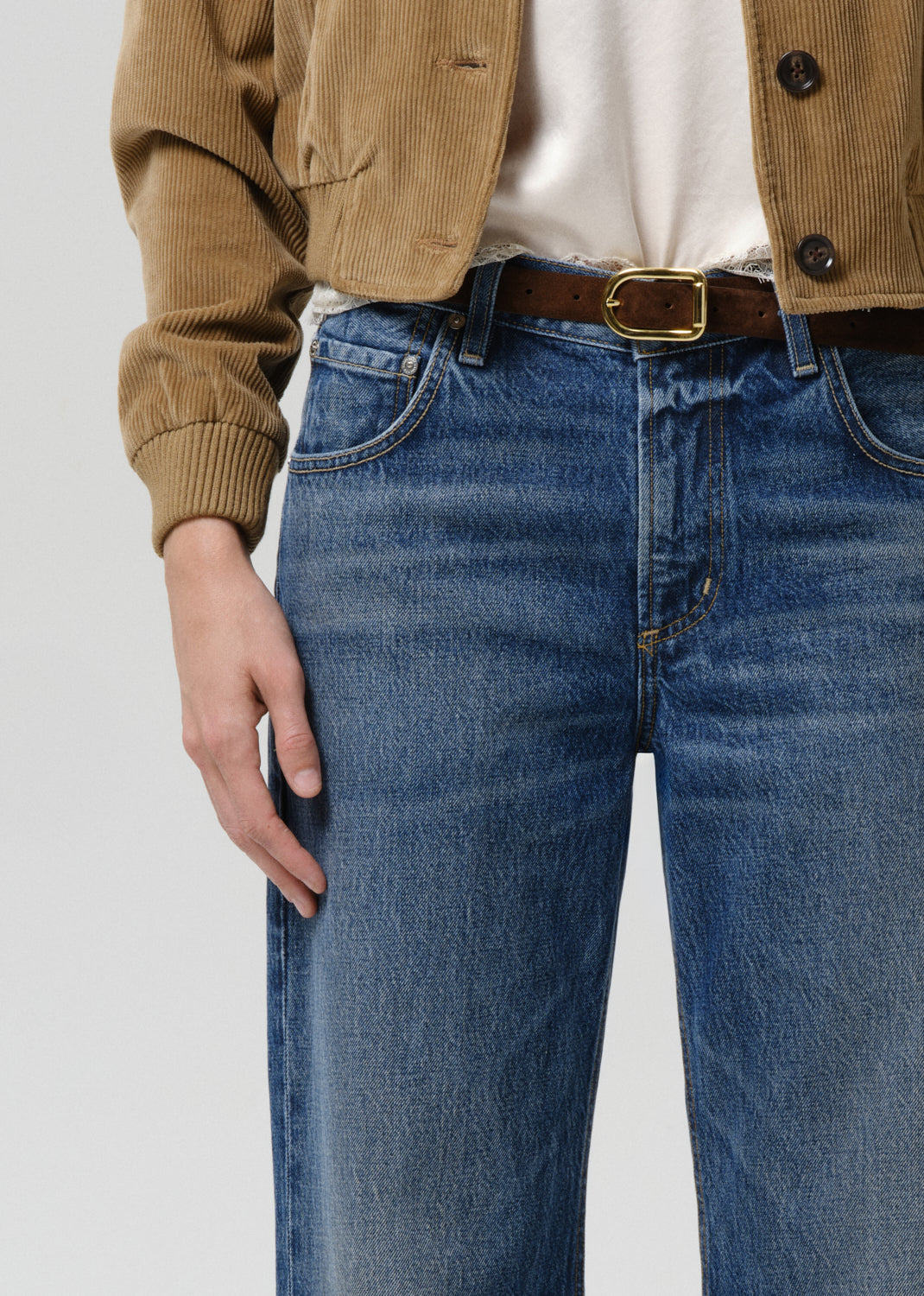 Close-up of Citizens of Humanity Lindz Easy Straight jeans in medium blue Twilight wash with brown belt