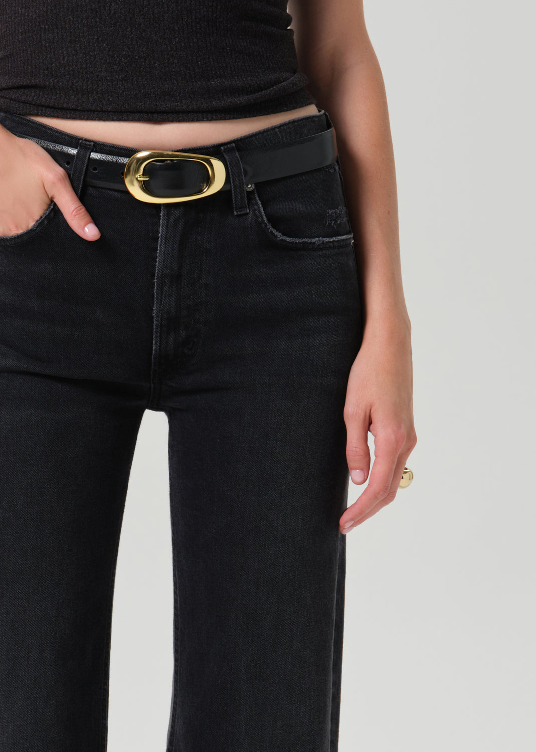 Close-up of model wearing Citizens of Humanity Kimberly 70s Flare jeans in washed black Cateye