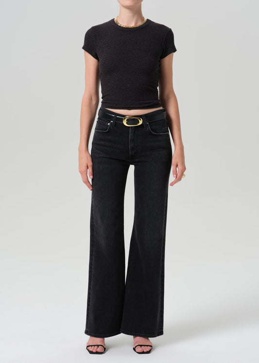 Model wearing Citizens of Humanity Kimberly 70s Flare jeans in dark washed black denim