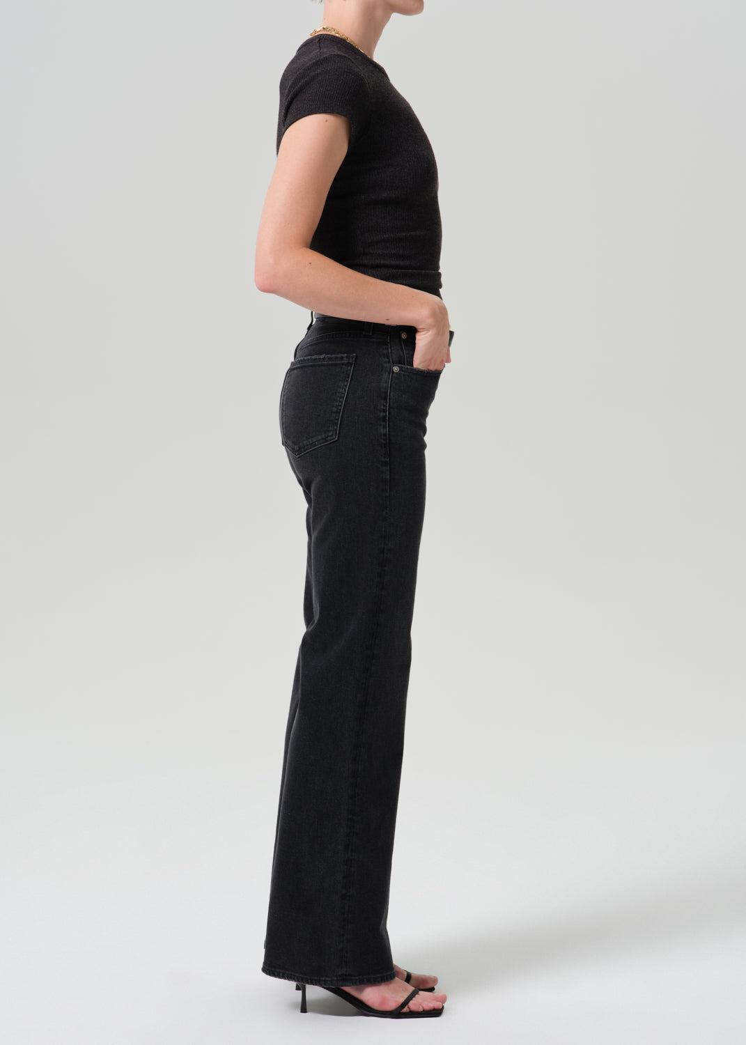 Side view of model wearing Citizens of Humanity Kimberly 70s Flare jeans in washed black Cateye