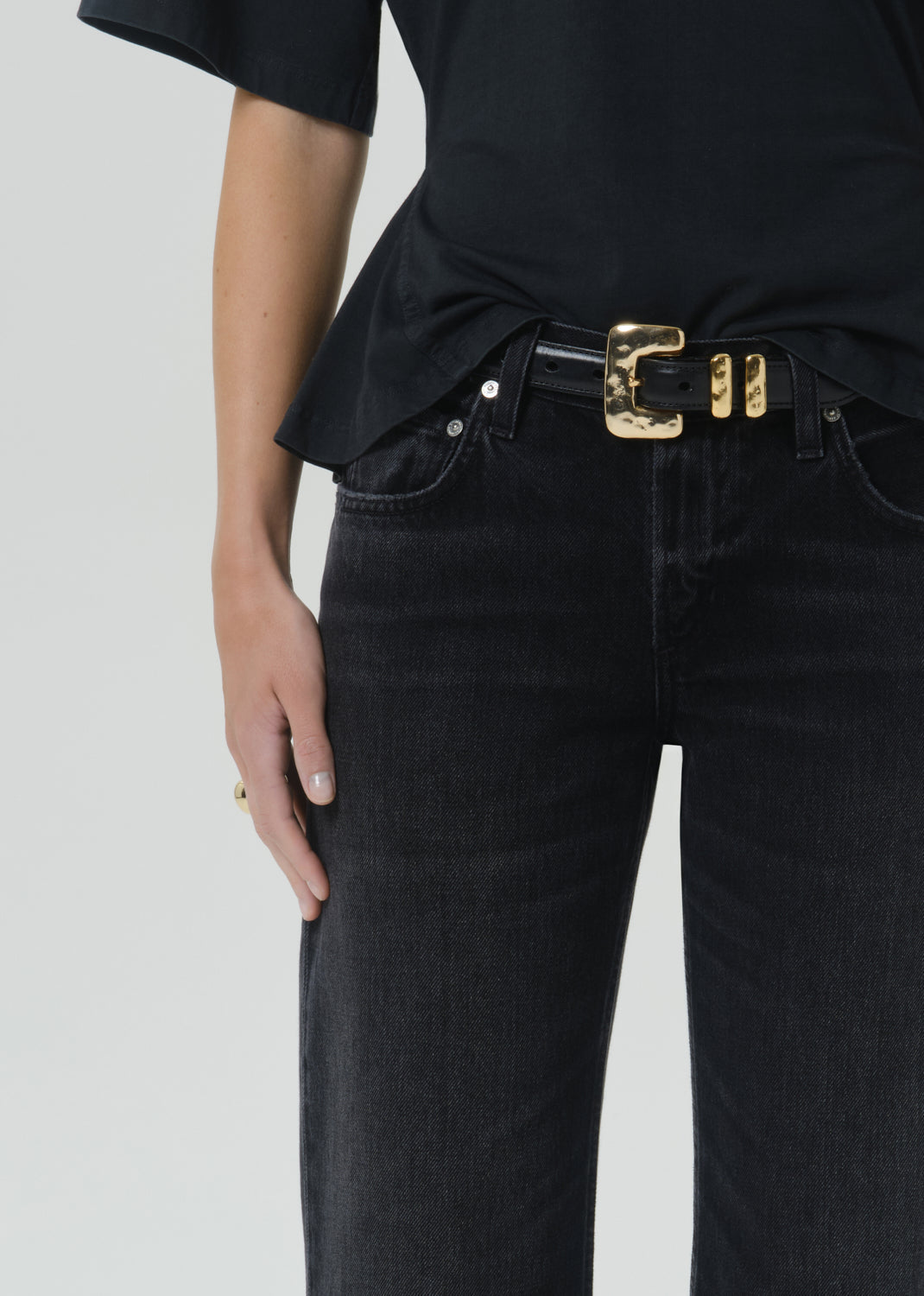 Close-up of Citizens of Humanity Faye Vintage Straight jeans in dark Raine wash with gold belt buckle