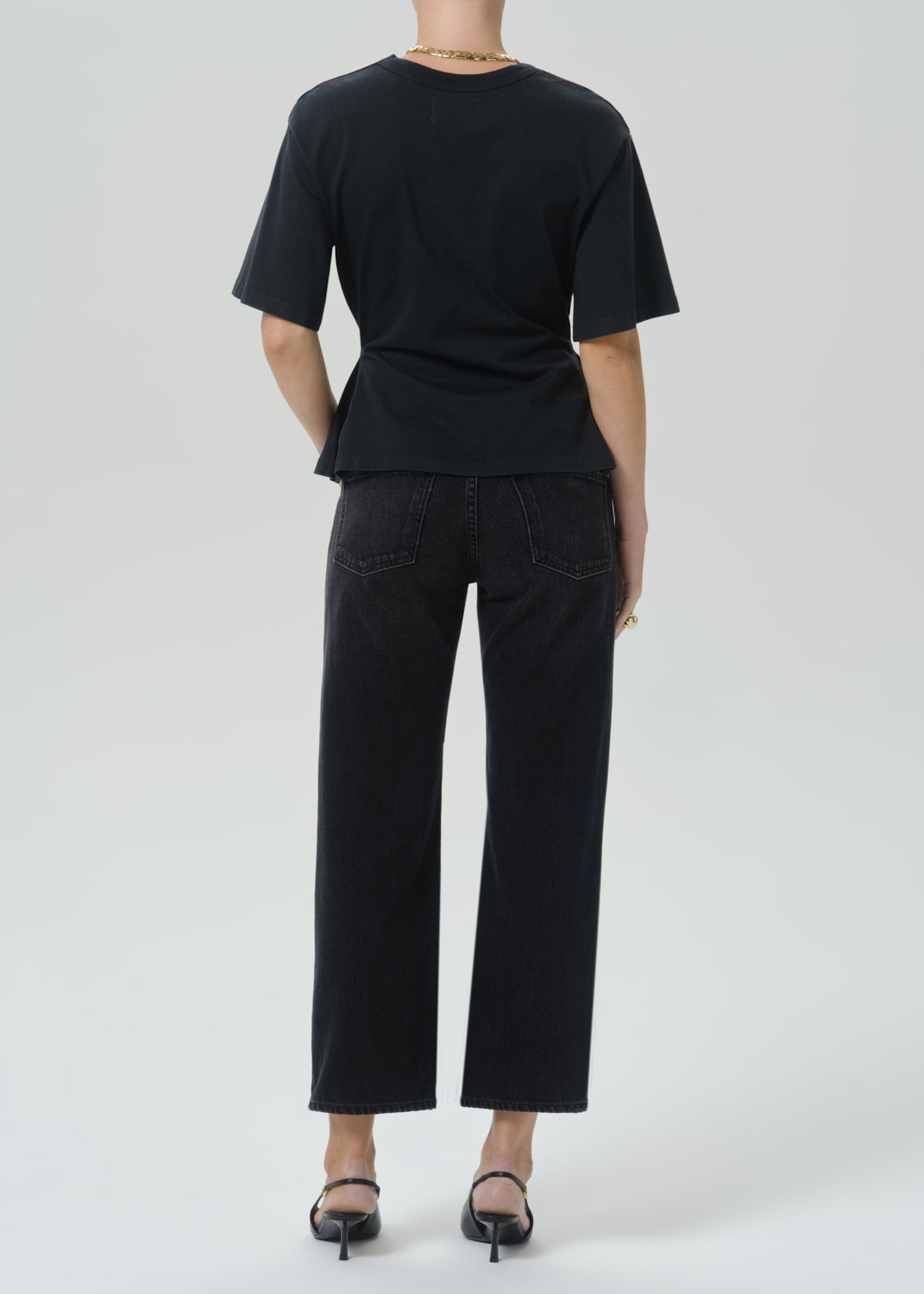 Back view of model wearing Citizens of Humanity Faye Vintage Straight jeans in Raine black wash