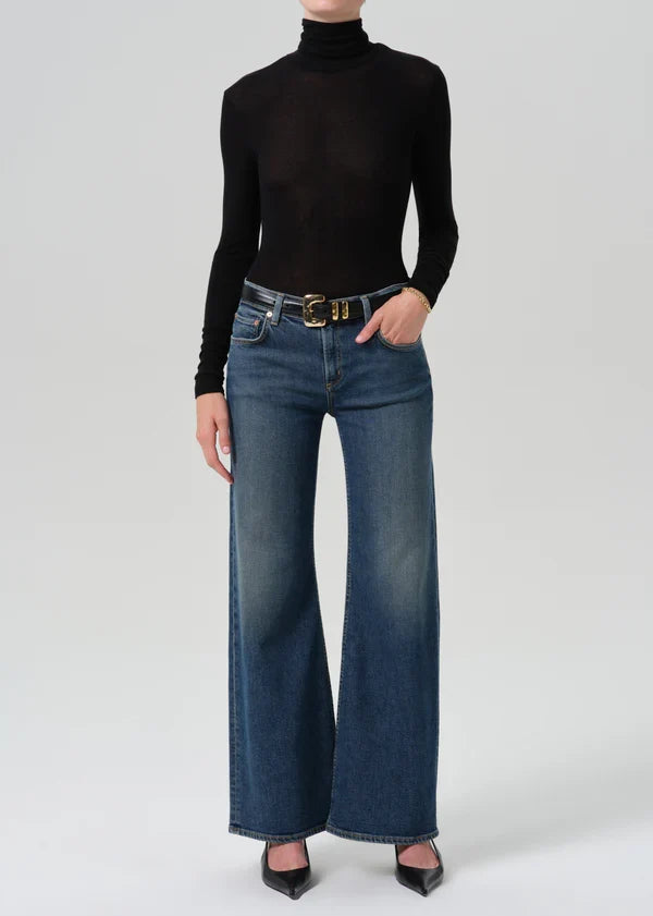 Model wearing Citizens of Humanity Nora wide-leg trouser jeans in dark indigo Nocturnal wash