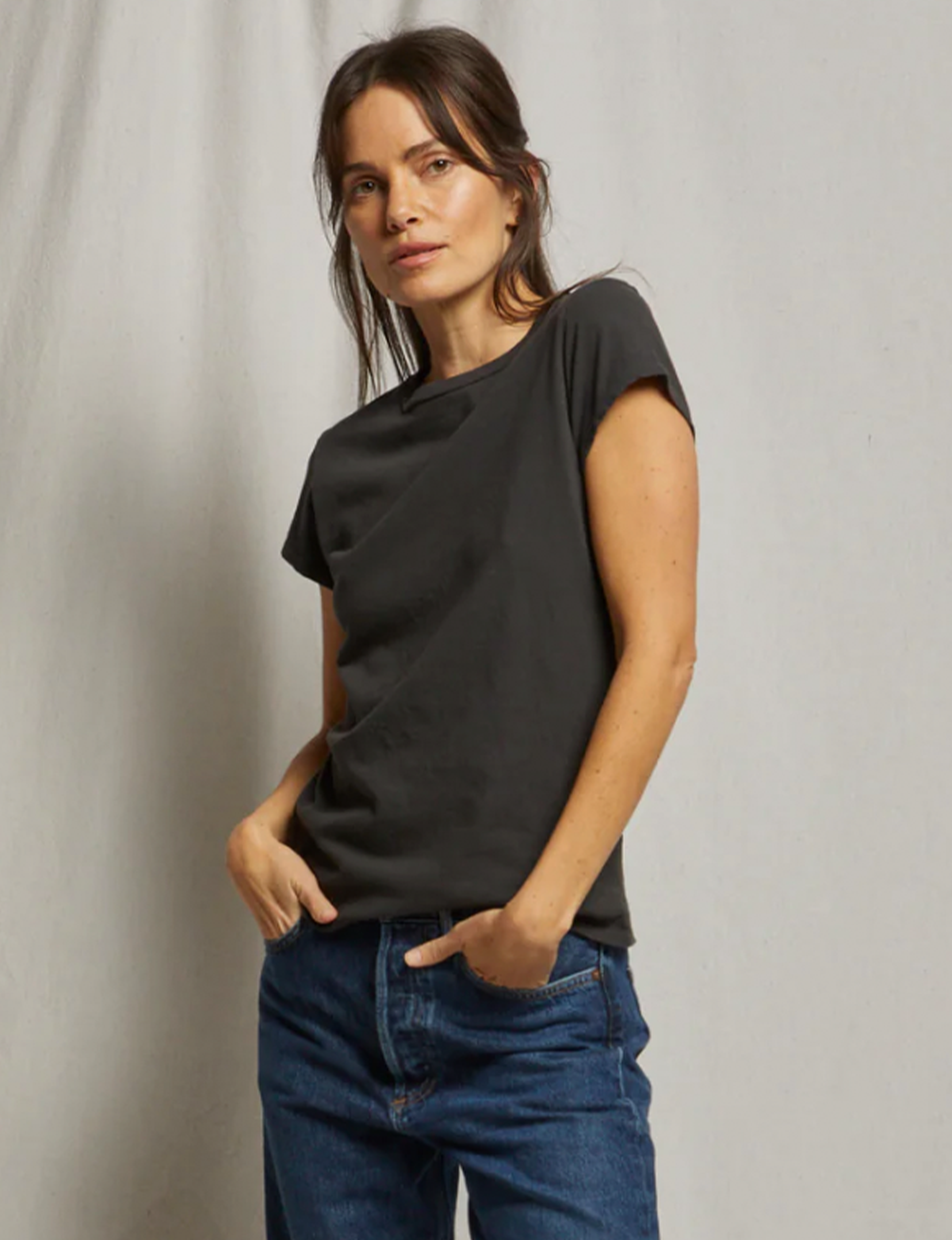 Woman wearing black short-sleeve t-shirt with blue jeans in professional lifestyle photo