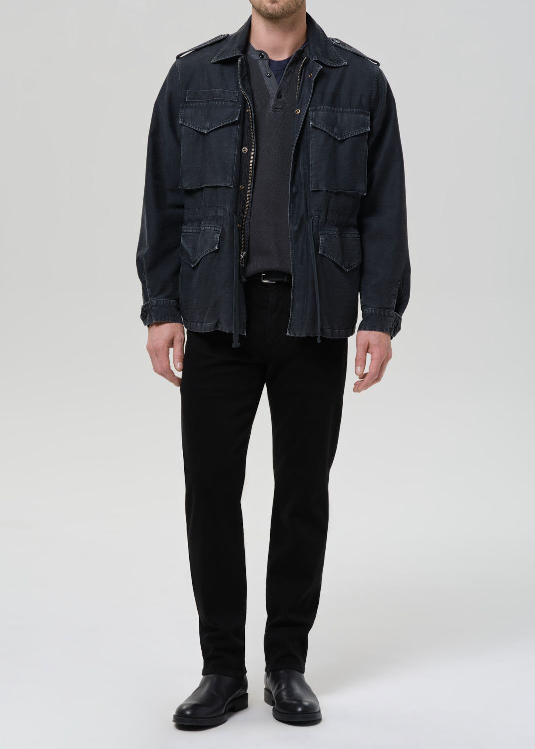Male model wearing Citizens of Humanity Elijah Straight black jeans with military jacket