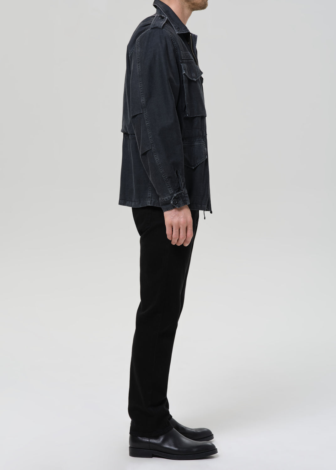 Male model wearing Citizens of Humanity Elijah Straight black denim jeans side view