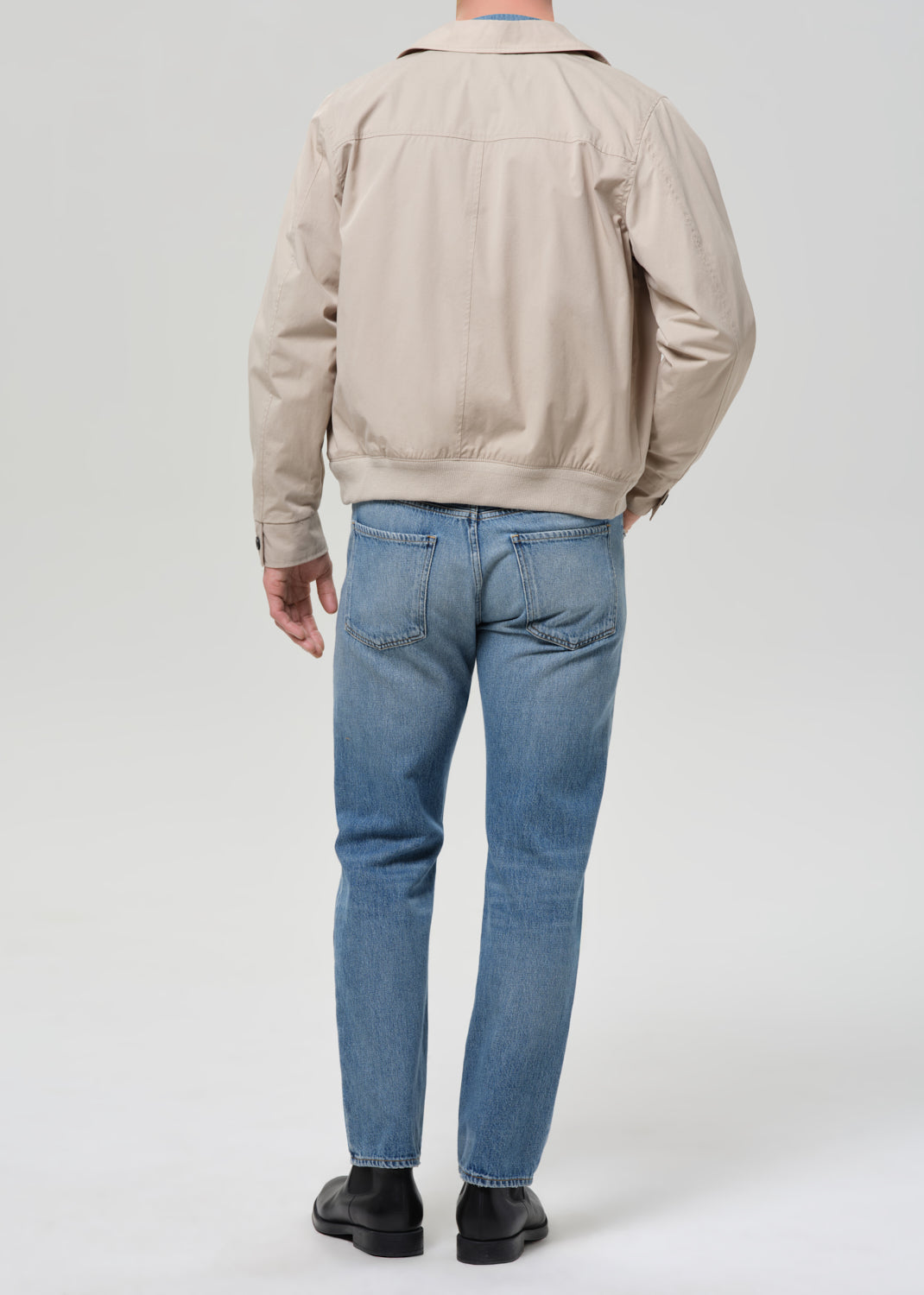 Back view of man wearing Citizens of Humanity Elijah straight jeans in Shadow Blue wash