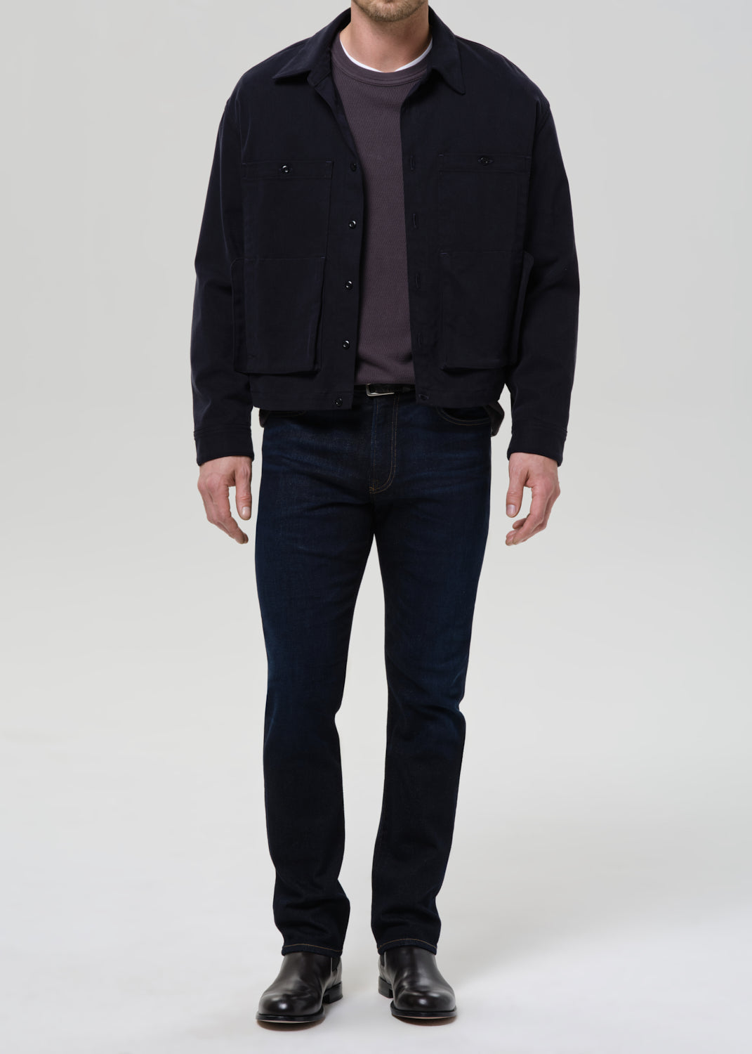 Man wearing Citizens of Humanity Elijah relaxed straight dark indigo cashmere denim jeans with navy jacket