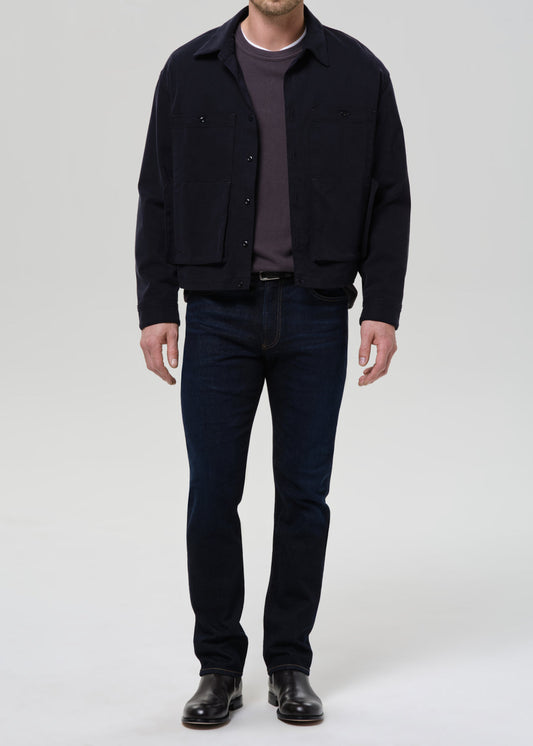 Man wearing Citizens of Humanity Elijah relaxed straight dark indigo cashmere denim jeans with navy jacket