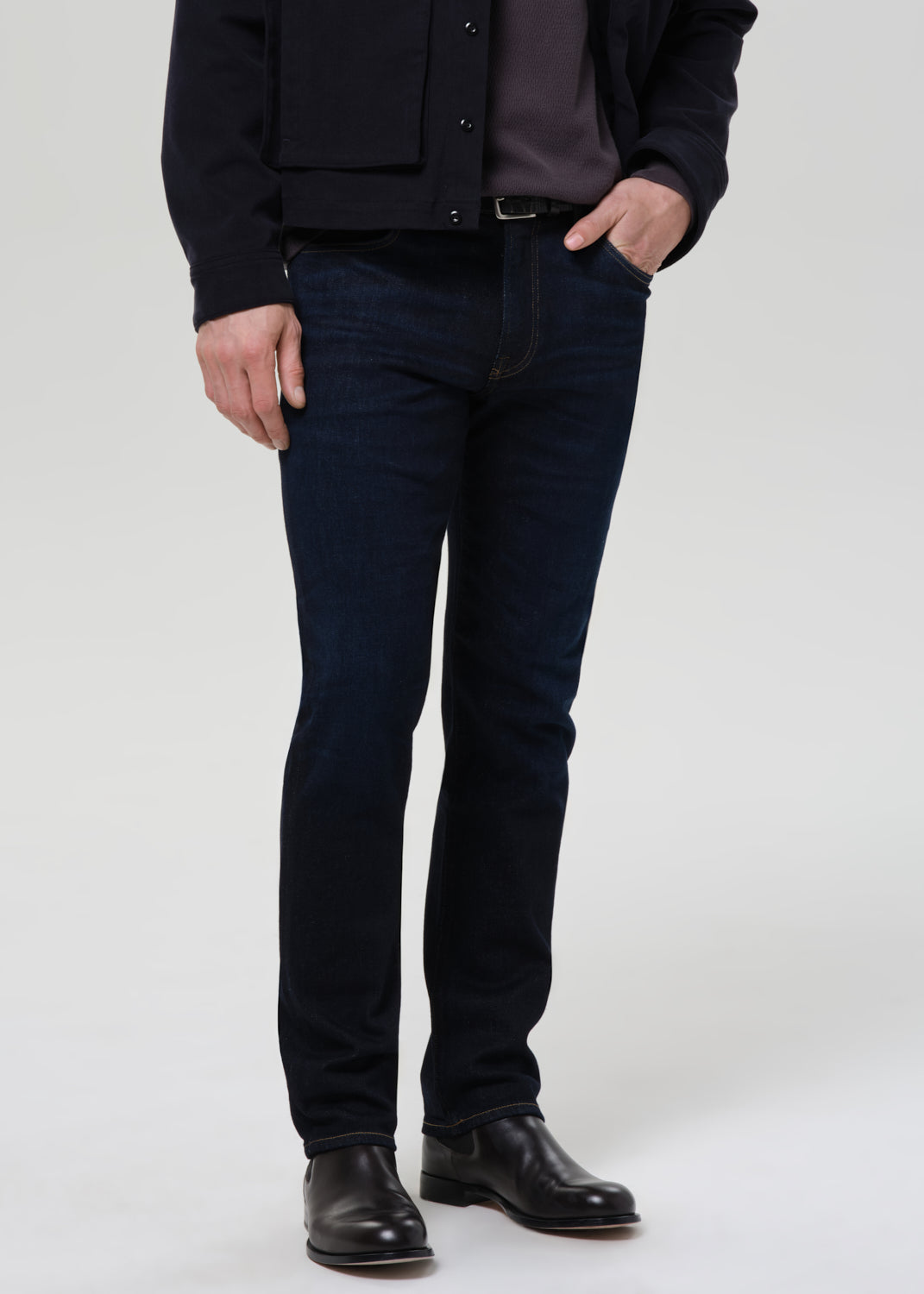 Male model wearing Citizens of Humanity Elijah relaxed straight dark indigo cashmere denim jeans with black boots