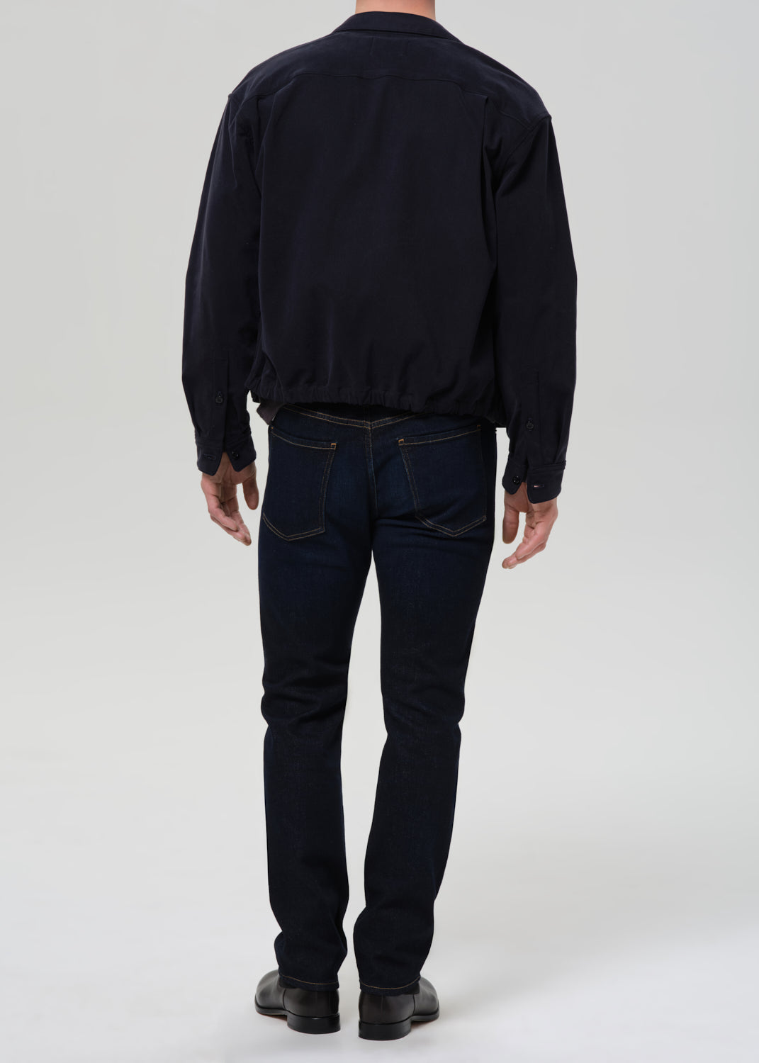 Back view of man wearing Citizens of Humanity Elijah relaxed straight dark indigo cashmere denim jeans