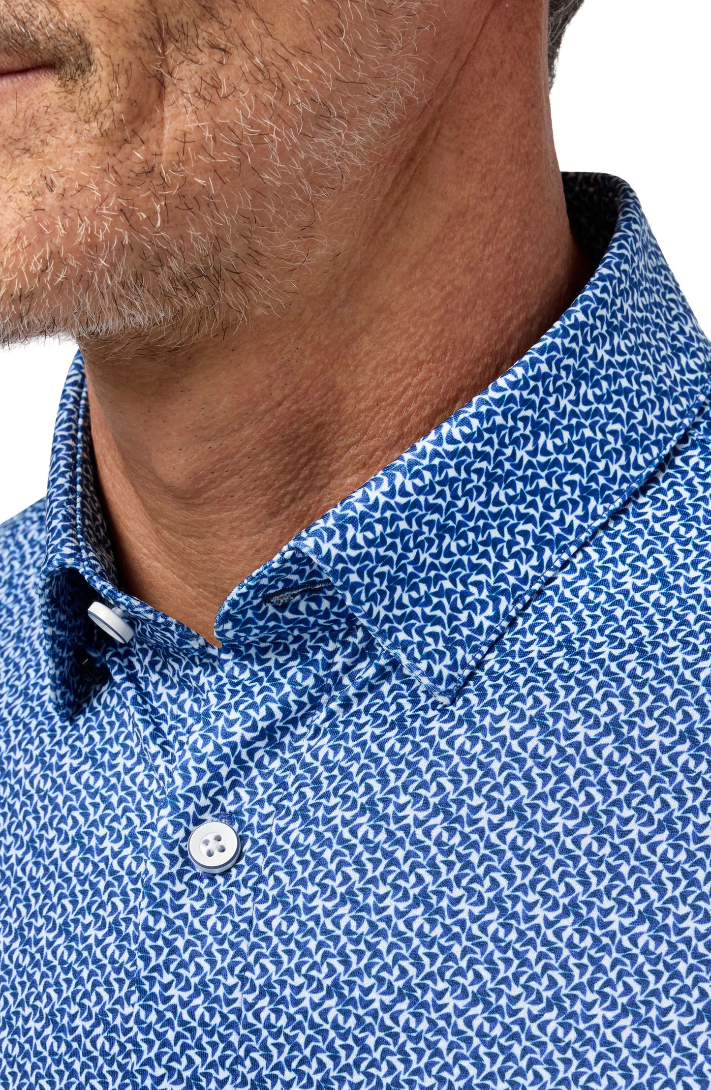 Close-up of cobalt blue boomerang print button-up shirt collar on male model