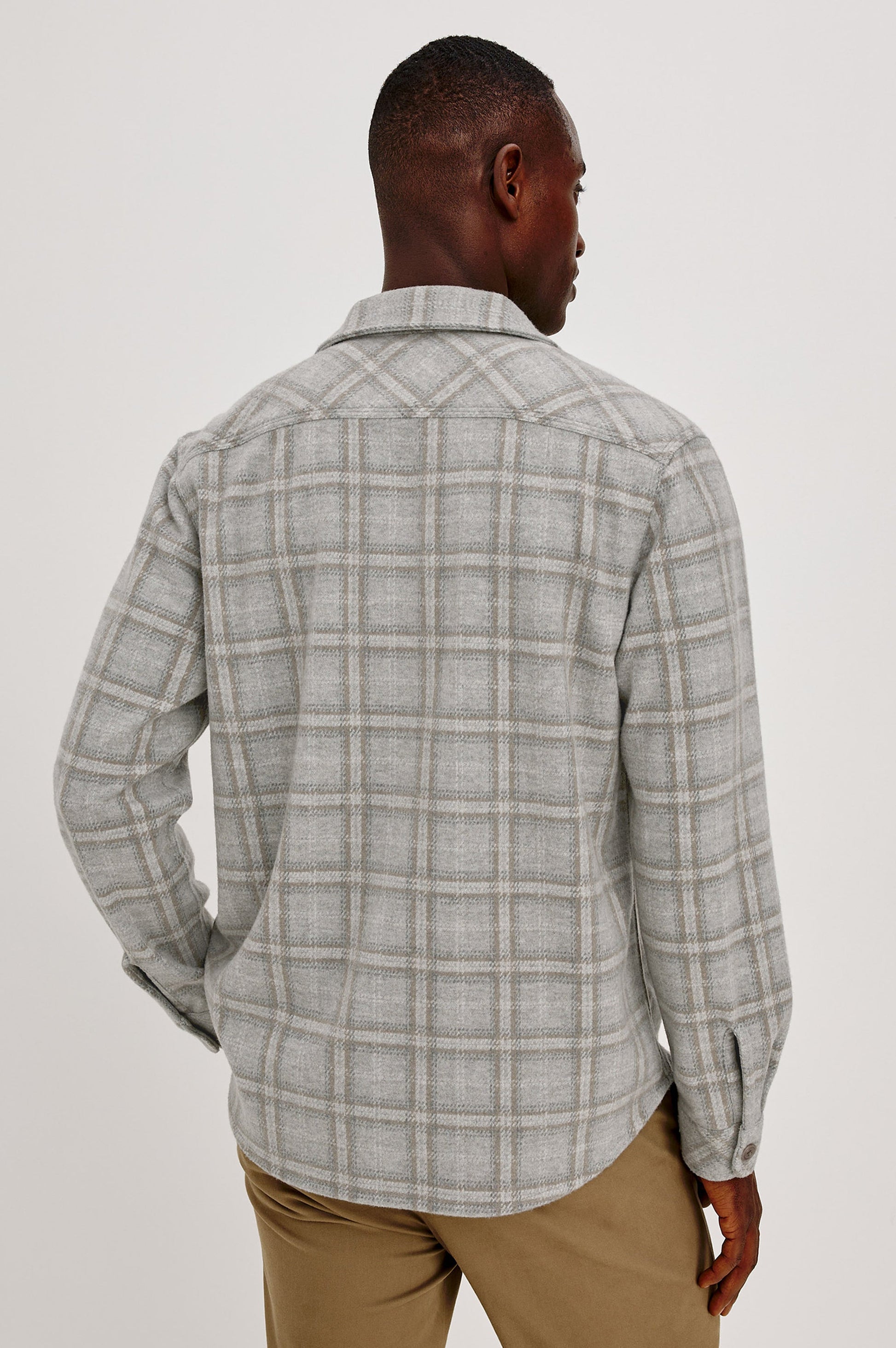 Back view of male model wearing Rails Alder plaid overshirt in quarry mist heather grey
