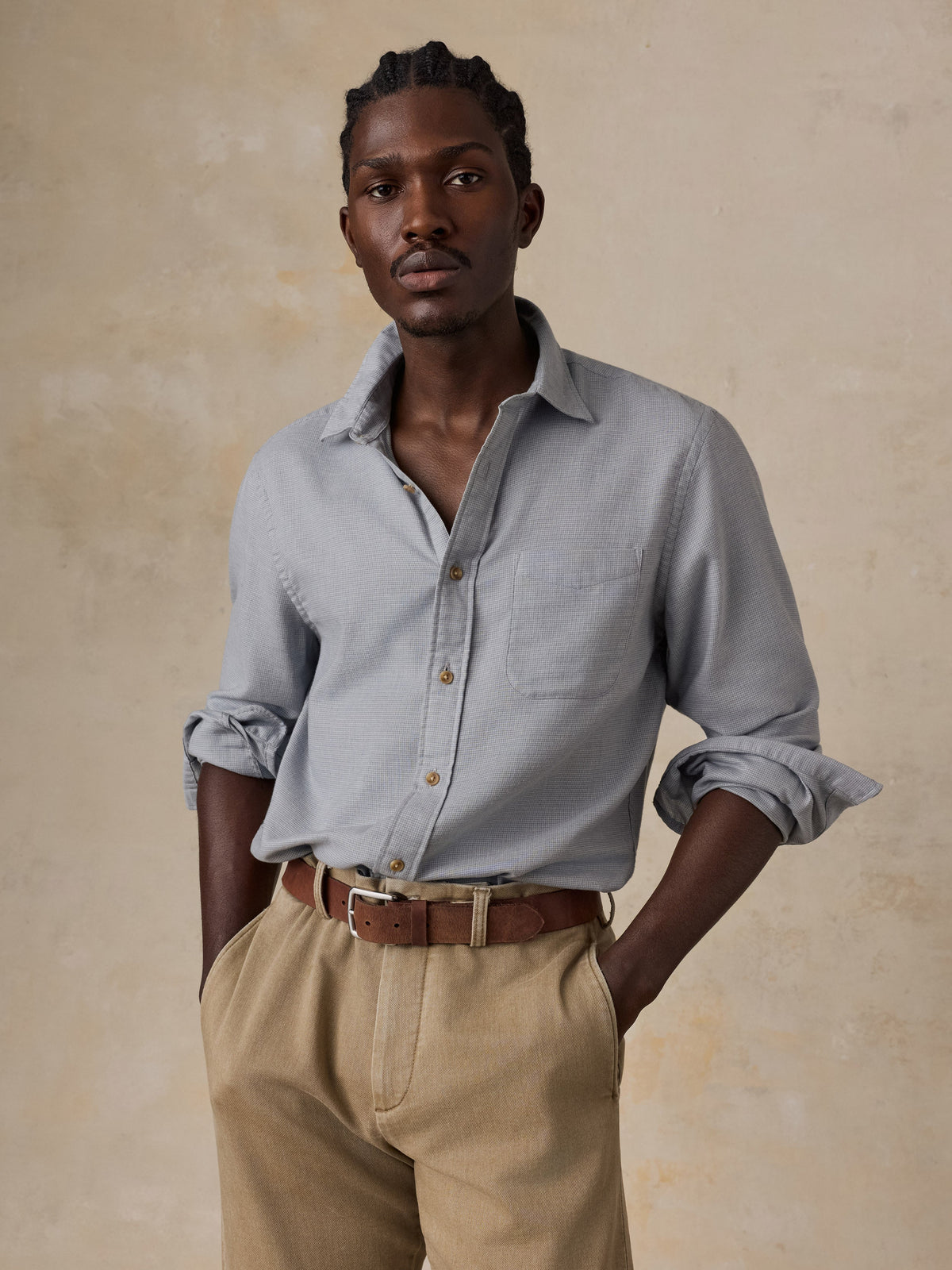 Male model wearing Faherty Timberline Brushed Twill Shirt in Mineral Grey with khaki trousers