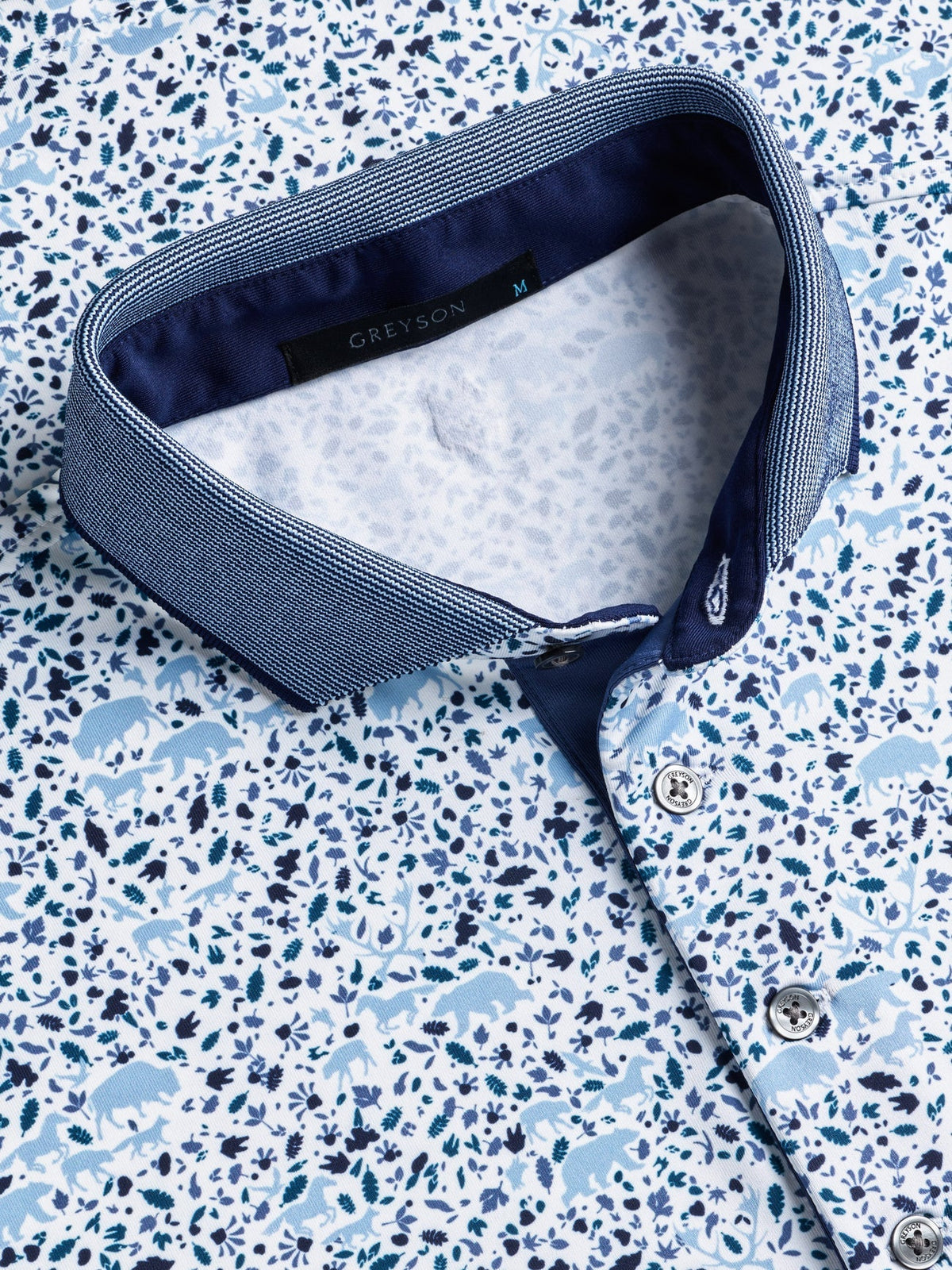Greyson Buffalo Soldier polo shirt in Arctic colorway featuring blue floral and animal print with navy collar