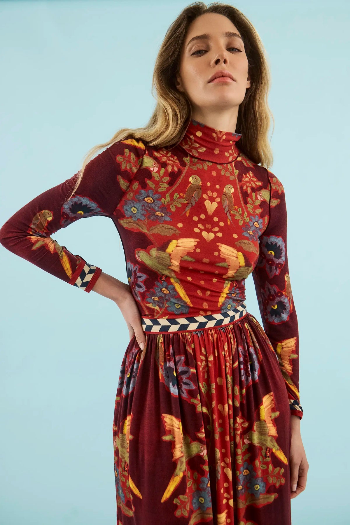 Model wearing Hunter Bell Wimberly skirt in maroon birds of a feather print with matching top