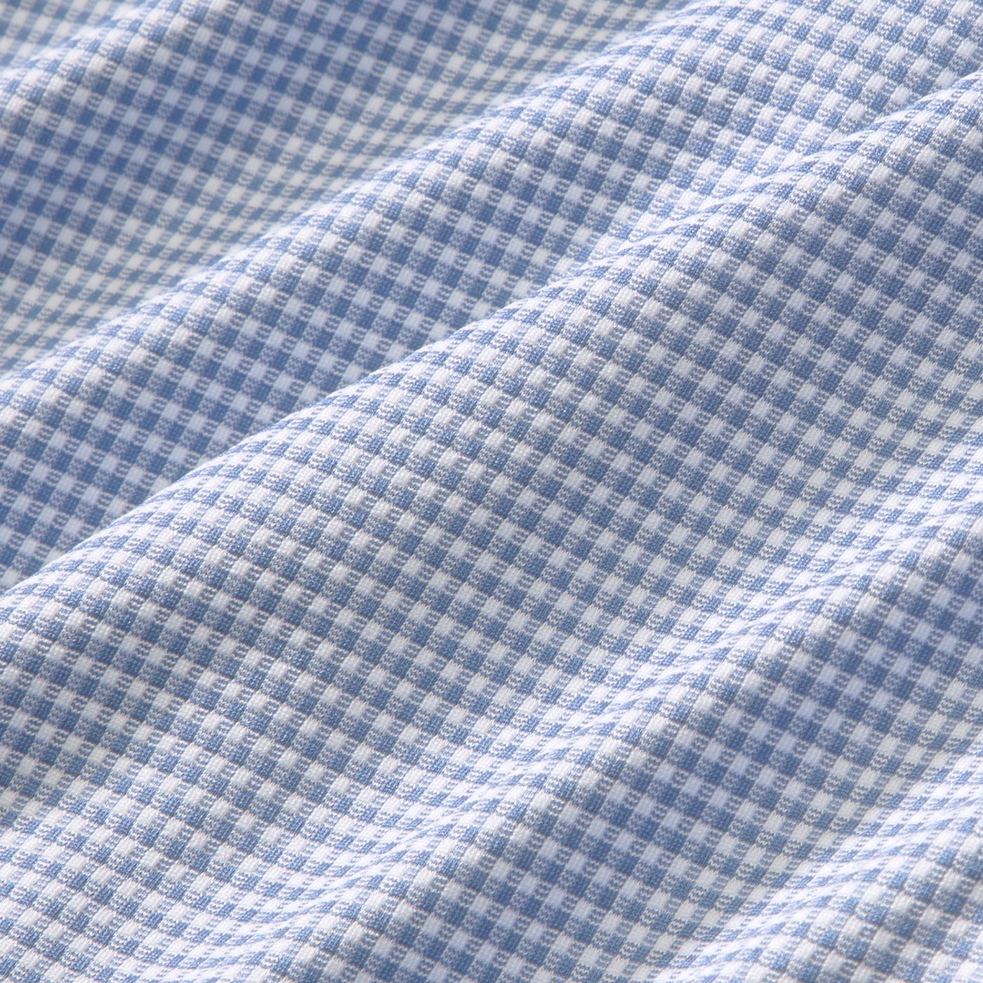 Close-up of blue and white micro gingham woven fabric with subtle texture and drape