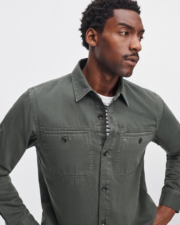 Male model wearing Rag & Bone dark green denim workwear shirt with chest pockets