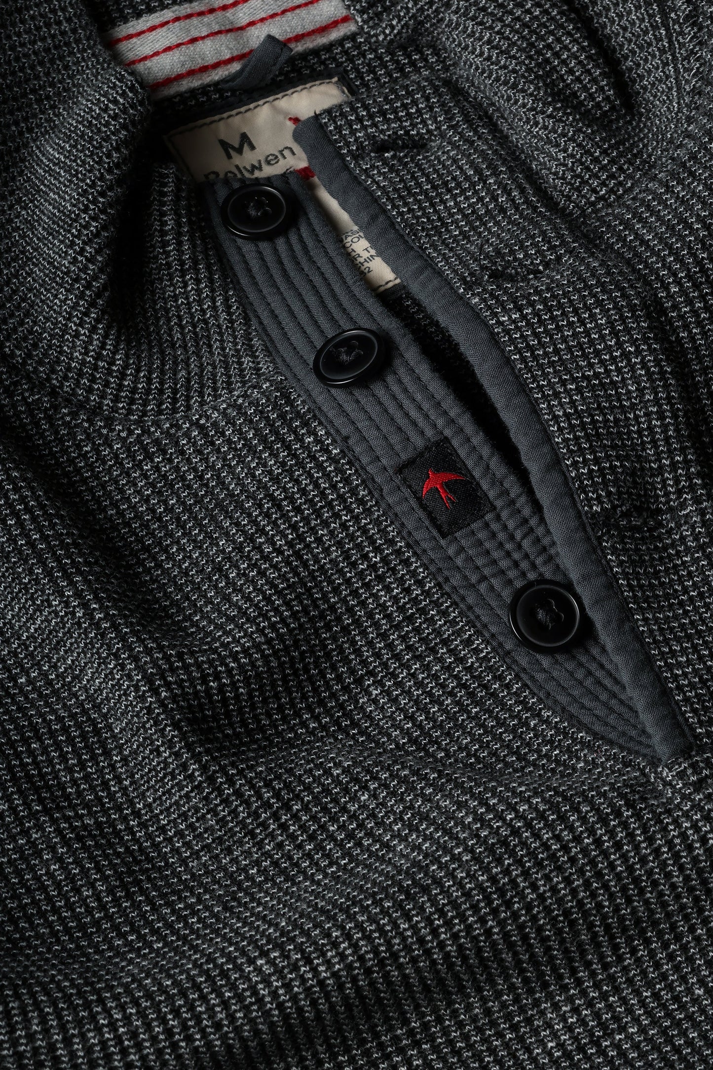Close-up detail of Relwen Bi-Waffle Mock sweater in dark charcoal showing buttons and label