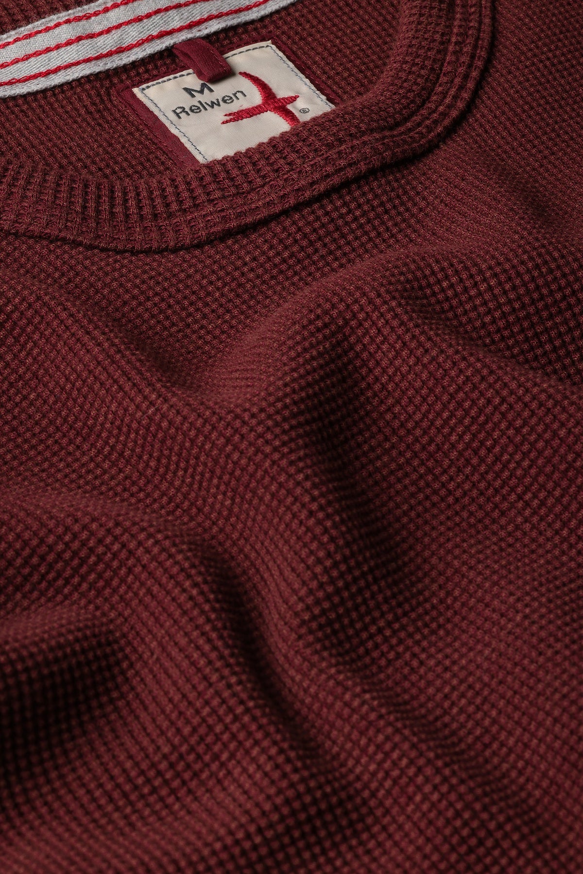 Close-up of Relwen Bi-Waffle Crew in burgundy showing waffle knit texture and label