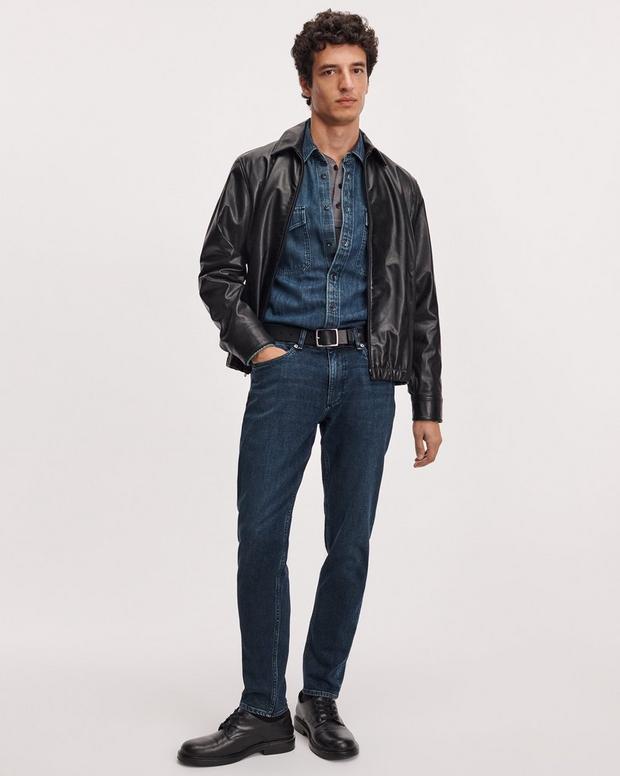 Male model wearing dark blue Rag & Bone Fit 3 Athletic stretch jeans with leather jacket