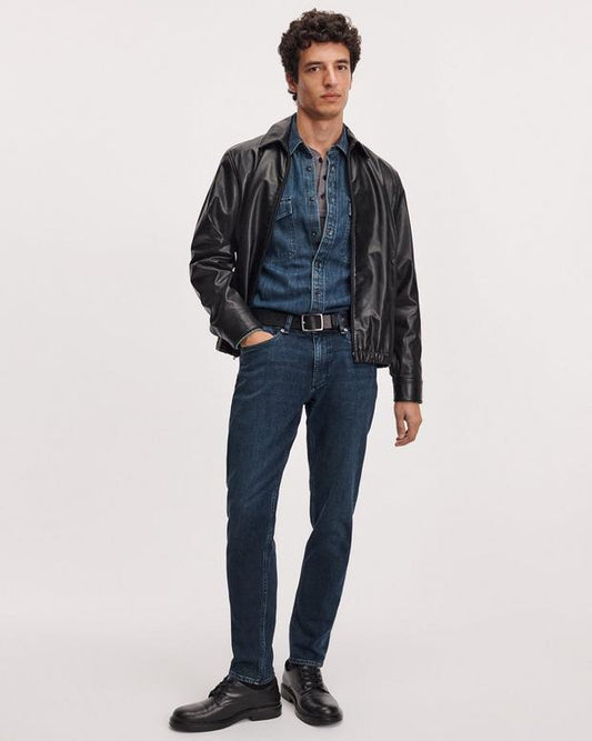 Male model wearing dark blue Rag & Bone Fit 3 Athletic stretch jeans with leather jacket