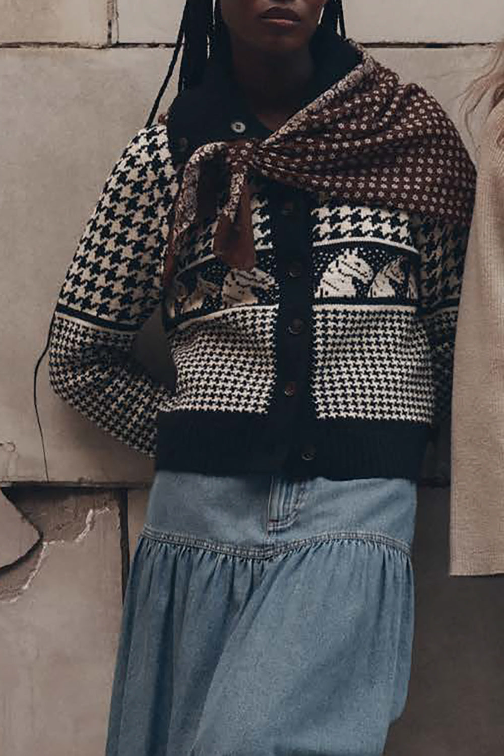 Model wearing black and cream houndstooth pony cardigan with denim skirt and scarf