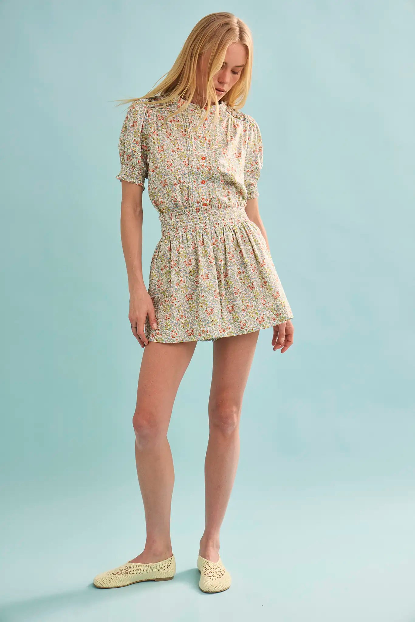 Woman wearing Hunter Bell Jemma floral print short dress with smocked waist