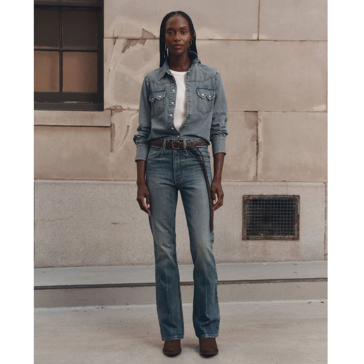 Model wearing The GREAT Howdy Top in Oldham Wash denim with snap buttons and chest pockets