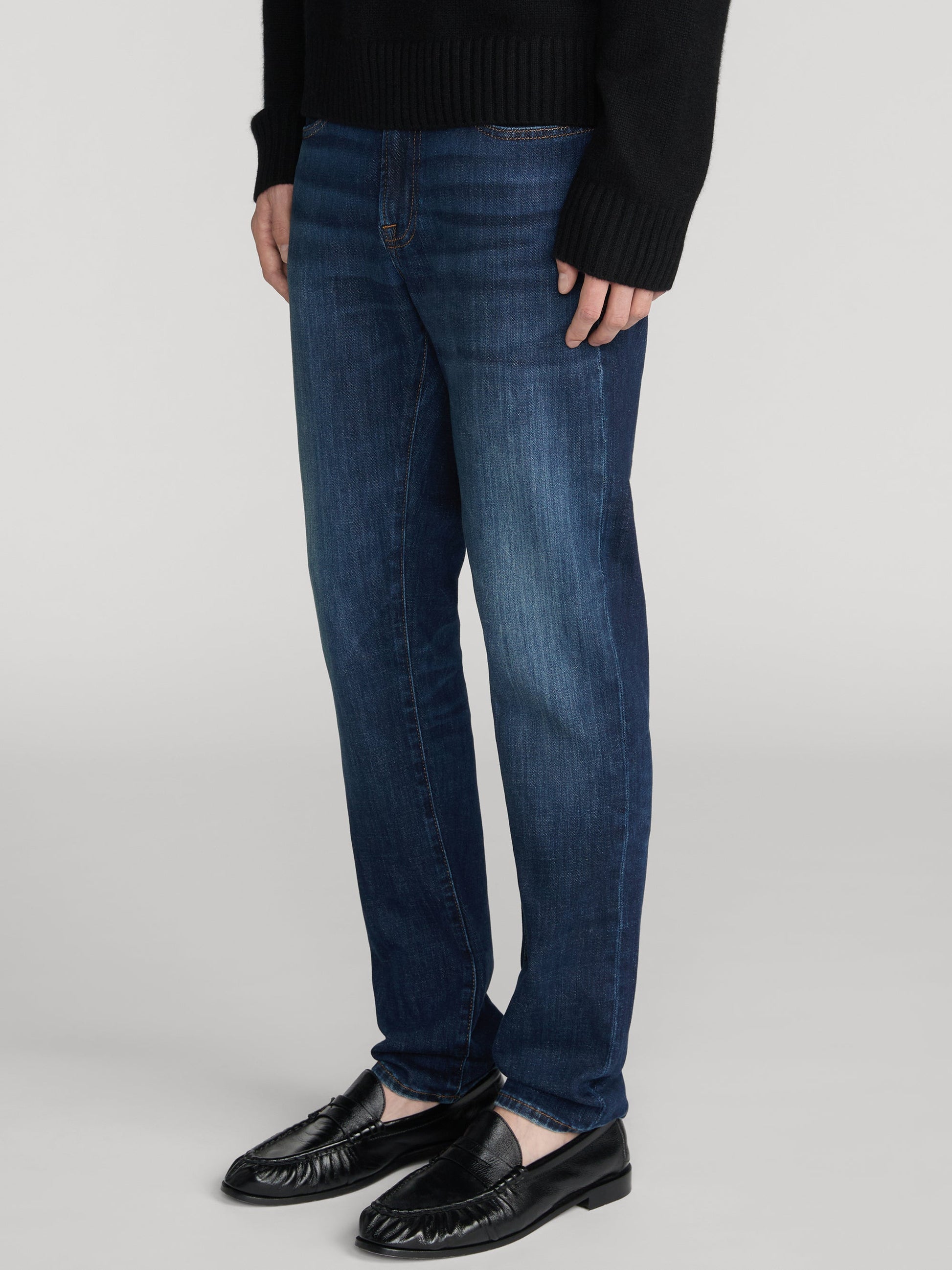 Frame L'Homme Slim Lasting jeans in dark indigo blue wash on male model