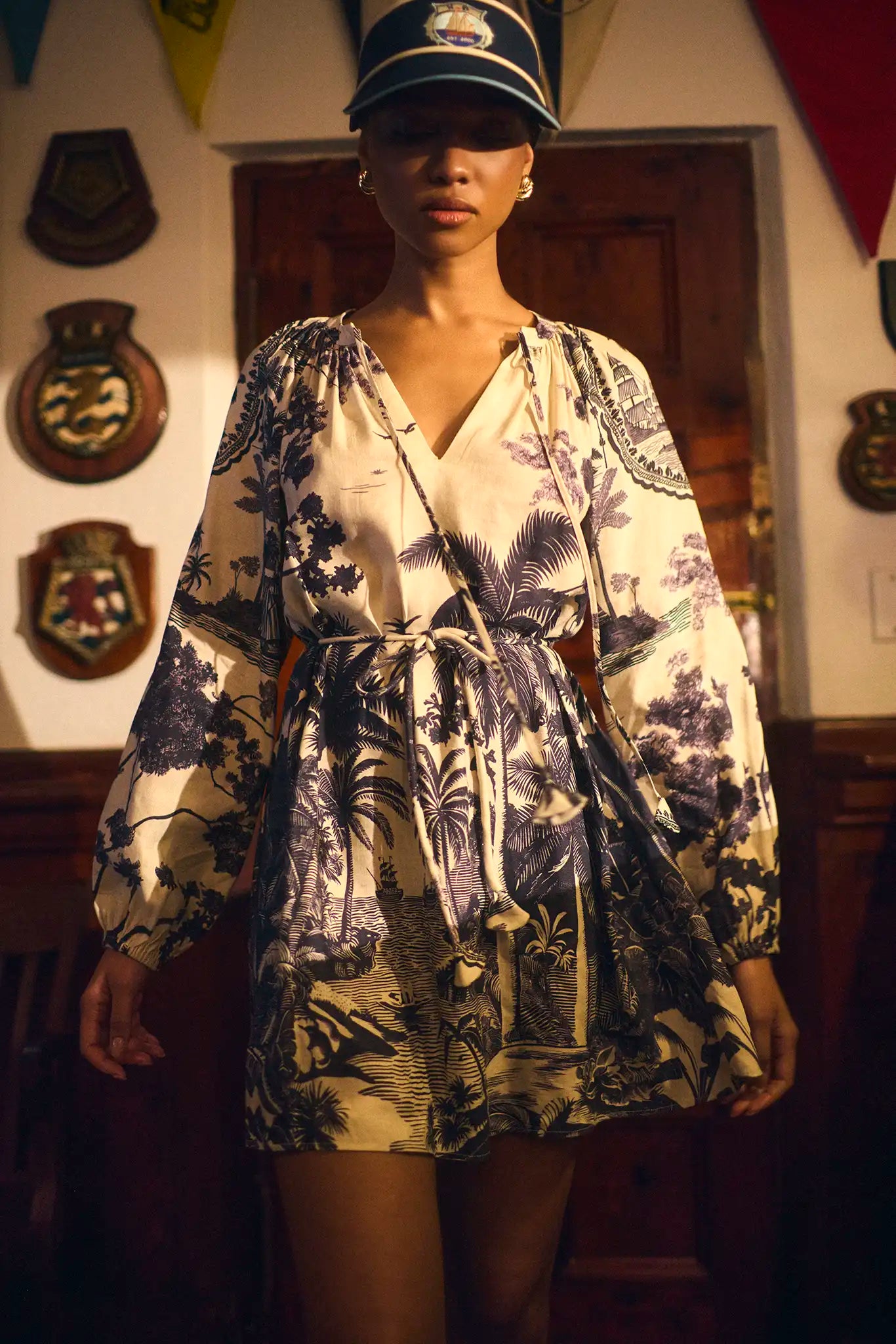 Model wearing Hunter Bell Lisette Dress in Bermuda Toile print with nautical cap