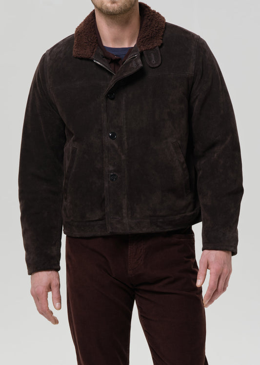 Man wearing dark brown suede jacket with sherpa collar and button front closure