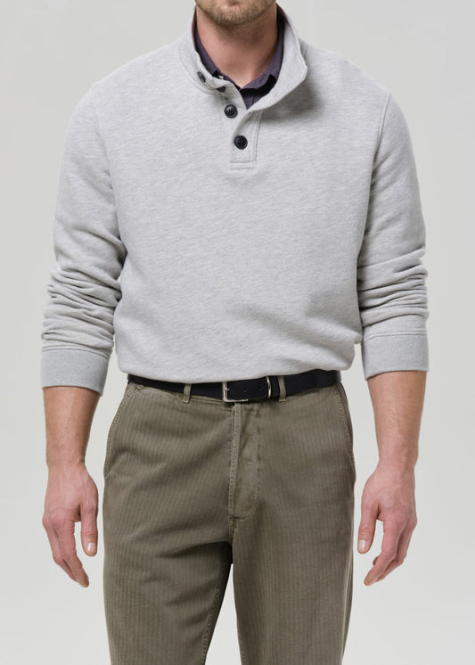 Male model wearing Citizens of Humanity heather grey half-button pullover sweatshirt with olive trousers