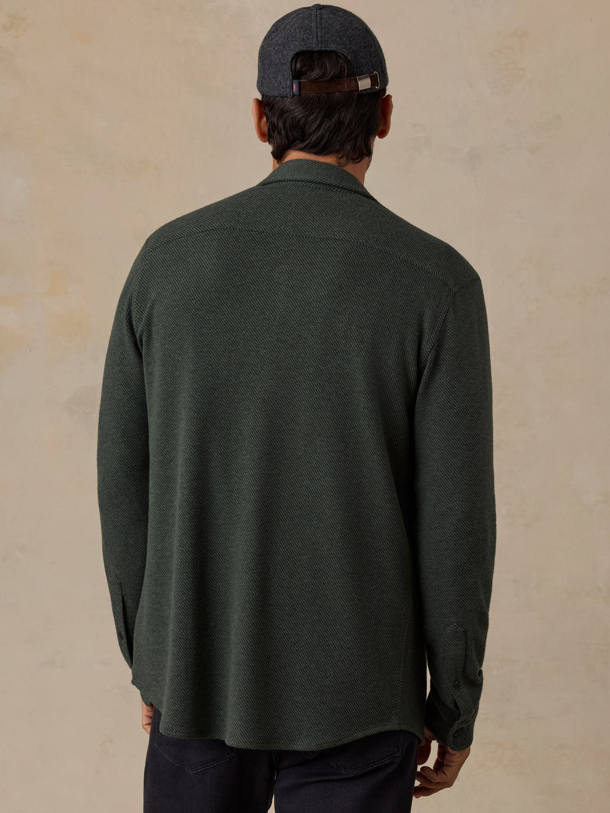 Back view of male model wearing Faherty Legend Sweater Shirt in Fall Evergreen Twill with baseball cap