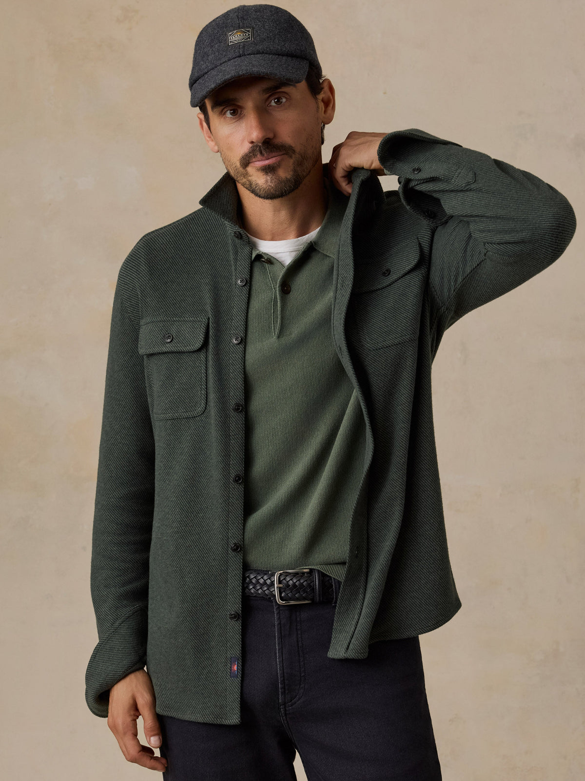 Male model wearing Faherty Legend Sweater Shirt in dark green twill with chest pockets