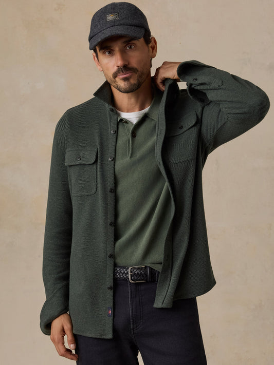 Male model wearing Faherty Legend Sweater Shirt in dark green twill with chest pockets